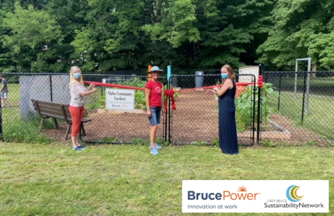 Anne Marie Shaw (left), Simona Freilbergova (middle), Maggie Tieman (right) posing in front of Alpha Street Community Garden
